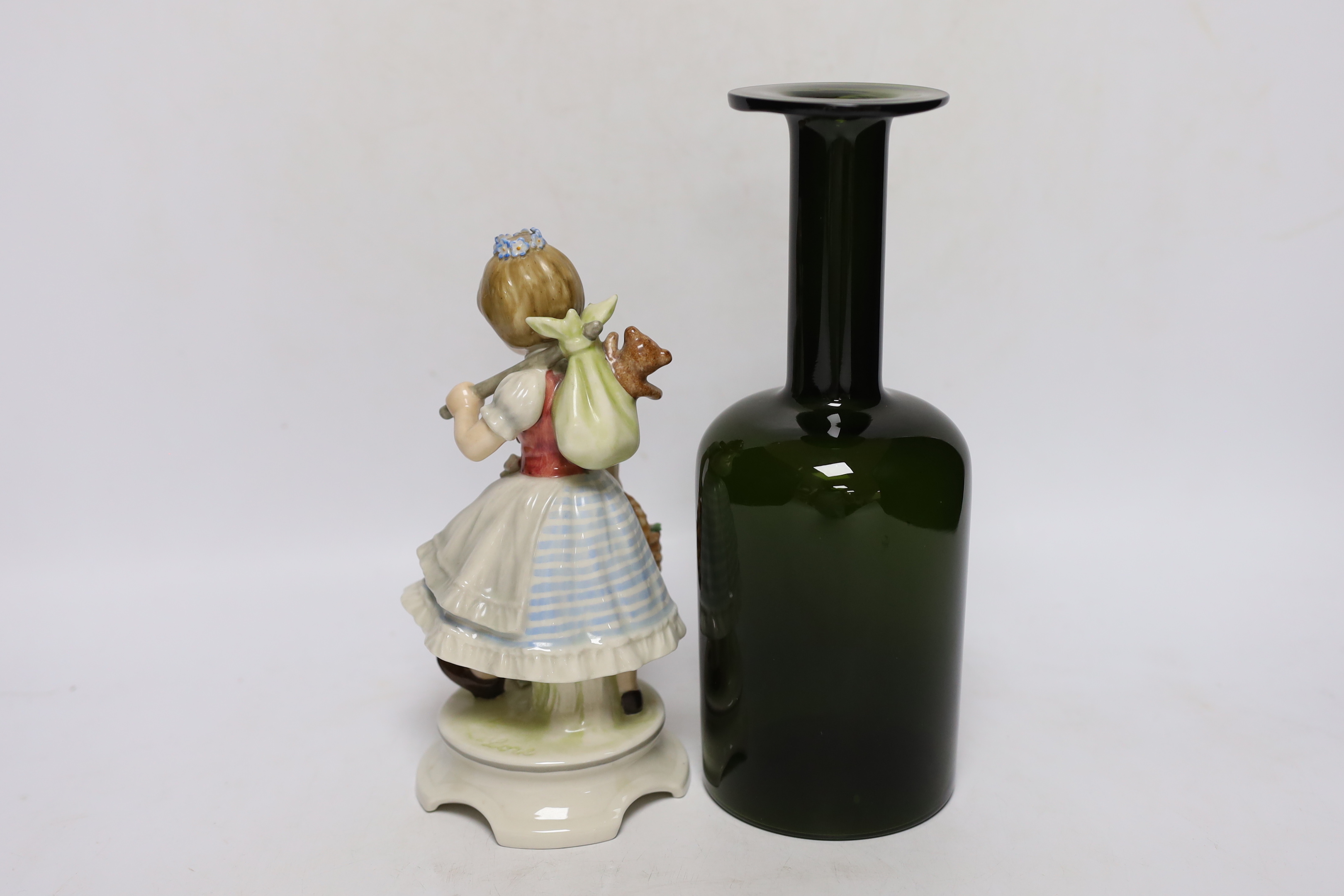 A 1960's Swedish green glass bottle vase and a Goebel figure group, Garden Princess, largest 25cm high